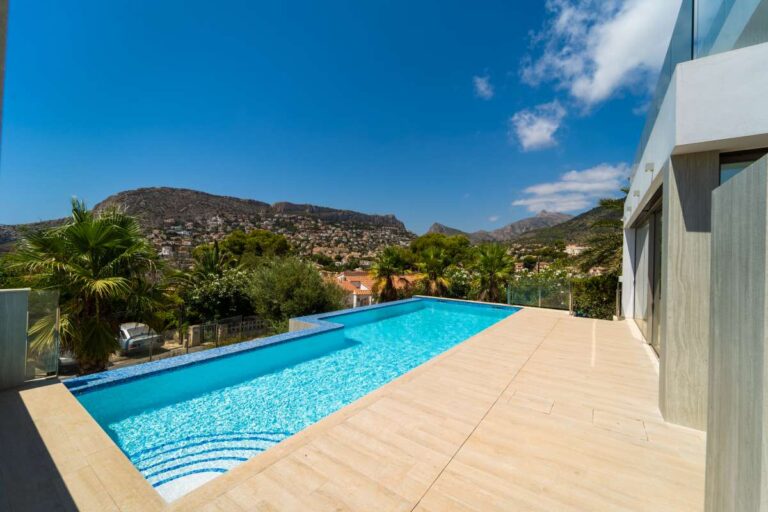 Pool terrace at a new-build luxury villa near Puerto Blanco Marina in Calpe with private swimming pool, mountain views and modern exterior design