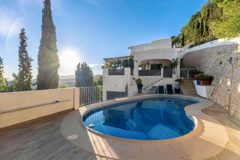 Pool terrace at a panoramic sea view villa in Benissa with private swimming pool, Mediterranean planting and views towards the coastline