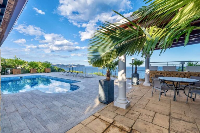 Pool terrace at a premium coastal villa on the Benissa Costa with private swimming pool, outdoor dining area and panoramic sea views