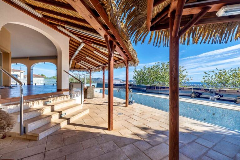 Pool terrace at a private villa in Calpe with covered seating area, Mediterranean sea views and outdoor kitchen space