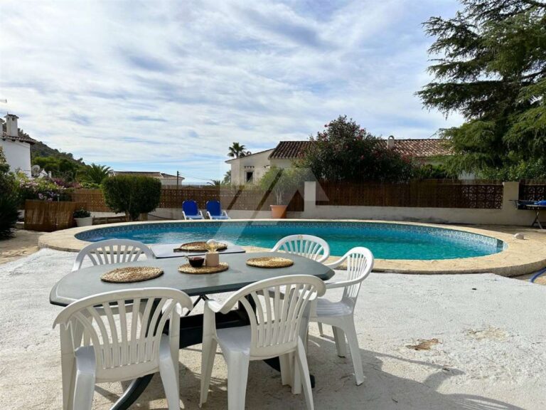 Pool terrace at a single-level villa near El Portet Beach in Moraira with outdoor dining table, private pool and sunny terrace area