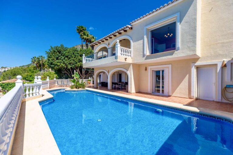 Pool terrace at an elegant Mediterranean villa in Altea Hills with private swimming pool, arched exterior and panoramic sea views