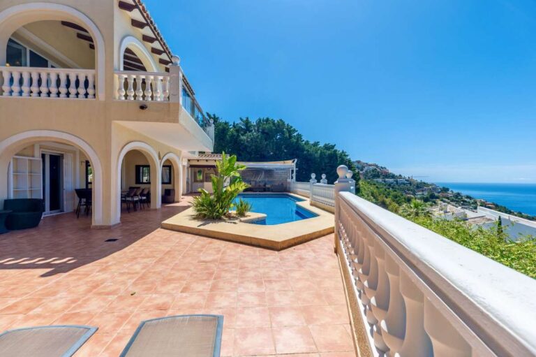 Pool terrace at an elegant Mediterranean villa in Altea Hills with private swimming pool, sun loungers and panoramic sea views