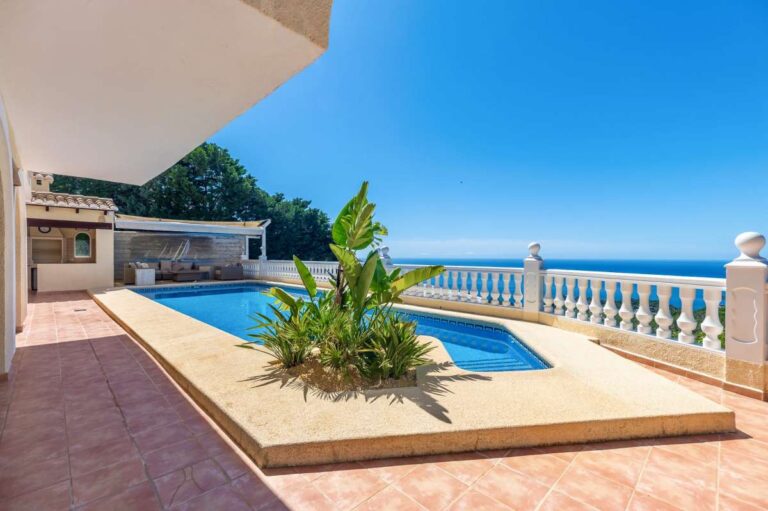 Pool terrace at an elegant Mediterranean villa in Altea Hills with private swimming pool, tropical planting and panoramic sea views