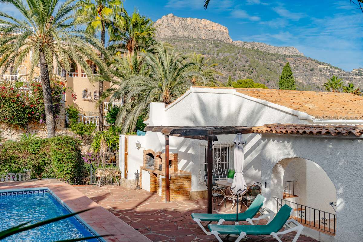 Pool terrace with mountain views, sun loungers and Mediterranean surroundings at a villa in Maryvilla, Calpe.