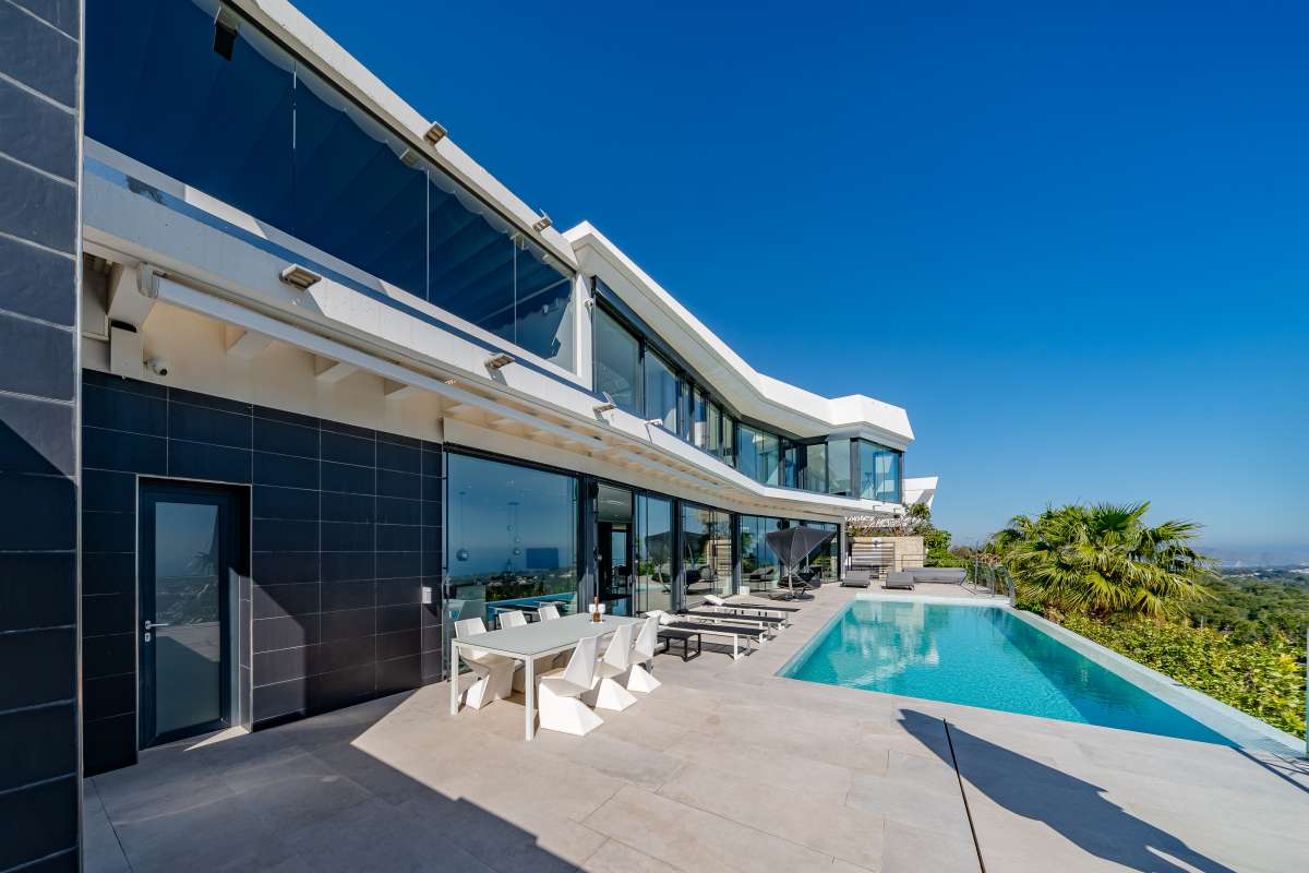 Pool terrace with outdoor dining area, infinity pool and panoramic sea views at a luxury villa in Gran Sol, Calpe.