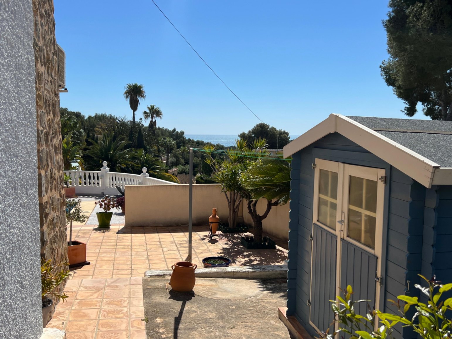Pool terrace with storage shed at Mediterranean villa in Benissa