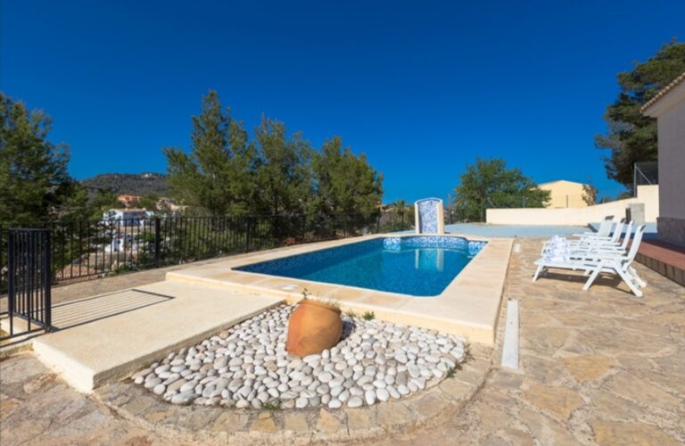 Pool terrace with sun loungers at a Mediterranean villa in a tranquil residential area of Calpe.