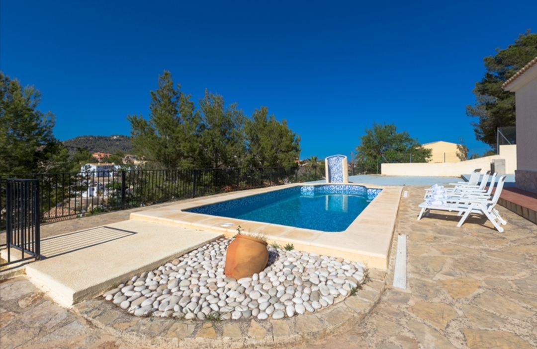Pool terrace with sun loungers at a Mediterranean villa in a tranquil residential area of Calpe.