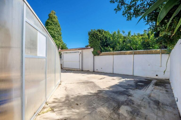 Poolside driveway area at a Mediterranean villa in Benissa Costa with covered pool structure, white walls and private outdoor space