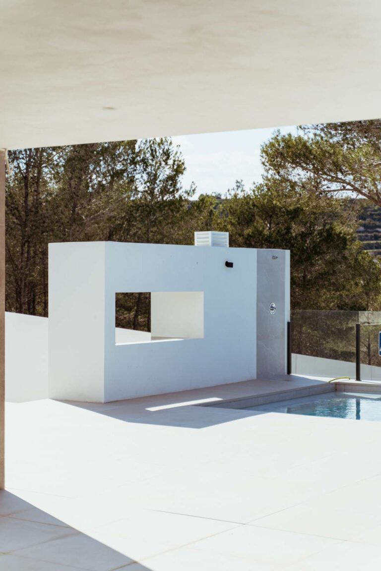 Poolside outdoor kitchen at a new-build luxury villa in Moraira with covered terrace, white worktop and modern outdoor cooking area