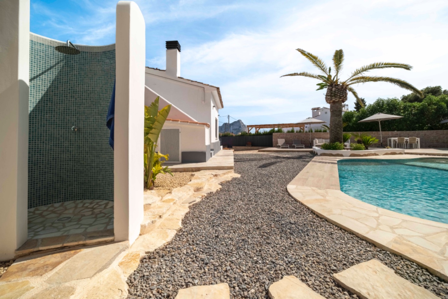 Poolside path and outdoor shower area at villa in Calpe