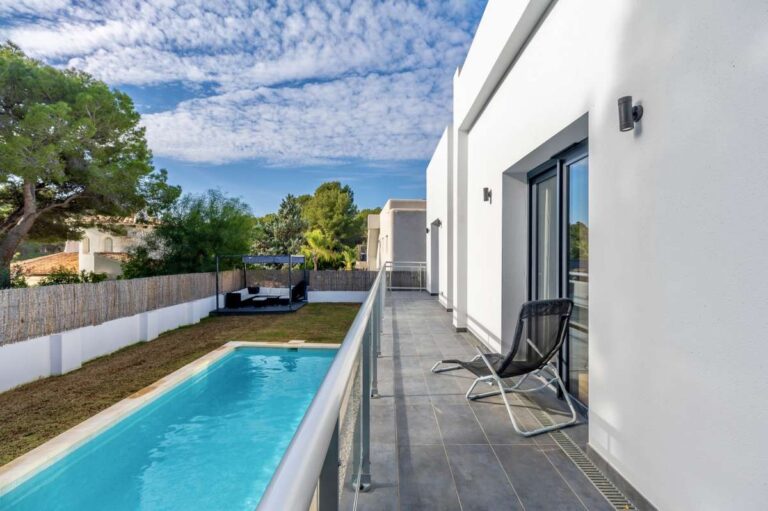 Poolside terrace at a single-level modern villa in Santa Clara, Altea with saltwater pool, white exterior, outdoor seating and private garden setting