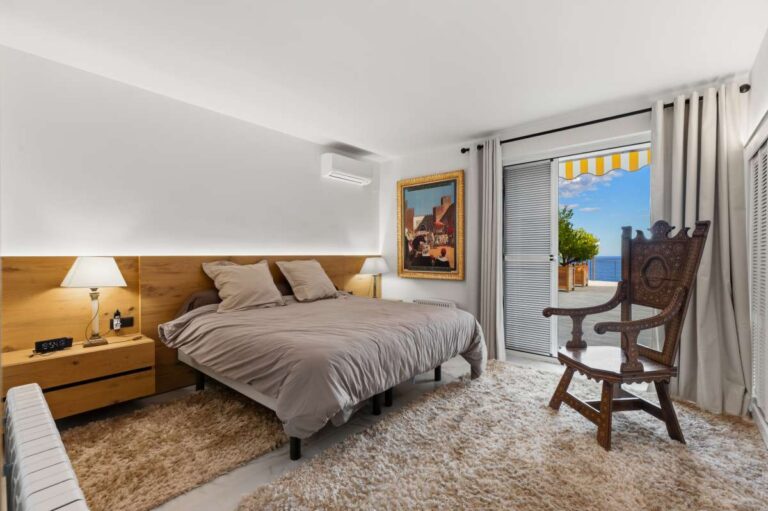 Principal bedroom inside a premium coastal villa on the Benissa Costa with terrace access, air conditioning, soft lighting and bright neutral finish