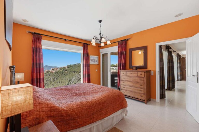 Principal bedroom inside an Altea Hills villa with mountain views, terrace access, en-suite access and bright Mediterranean interior