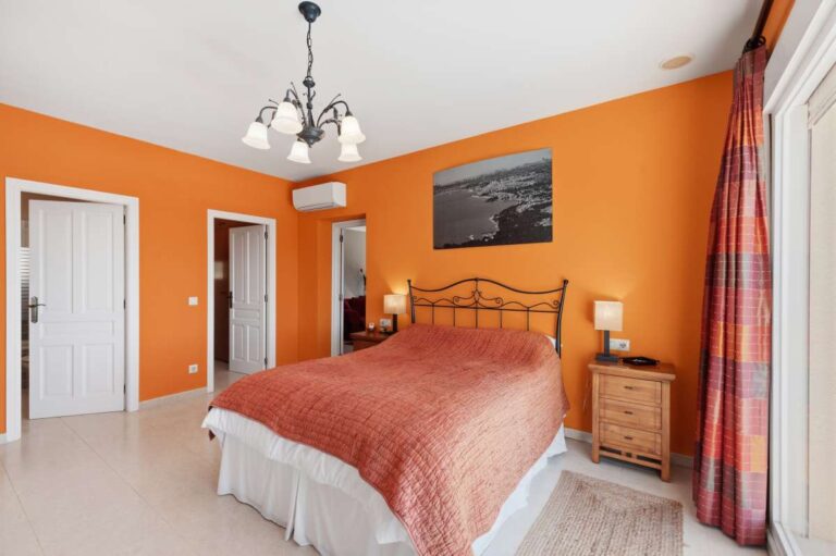 Principal suite inside an elegant Mediterranean villa in Altea Hills with en-suite access, workspace area and warm Mediterranean interior style