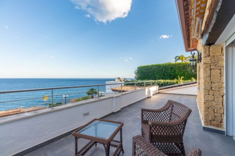 Private balcony at a premium coastal villa on the Benissa Costa with outdoor seating, glass railing and uninterrupted Mediterranean Sea views