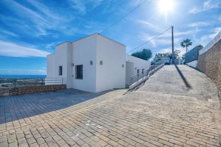 Private driveway and exterior view of a modern spacious villa with panoramic sea views in Calpe.