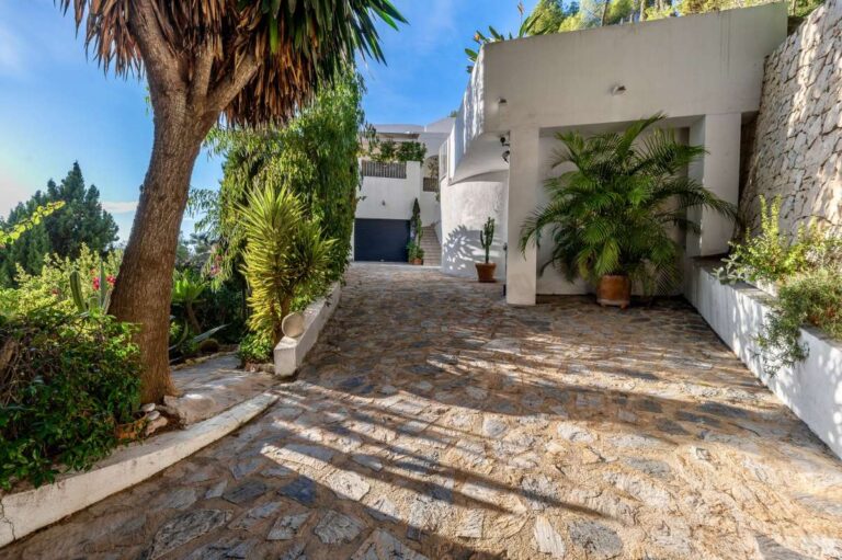 Private driveway at a Benissa sea view villa with stone paving, Mediterranean planting and access to the independent living areas