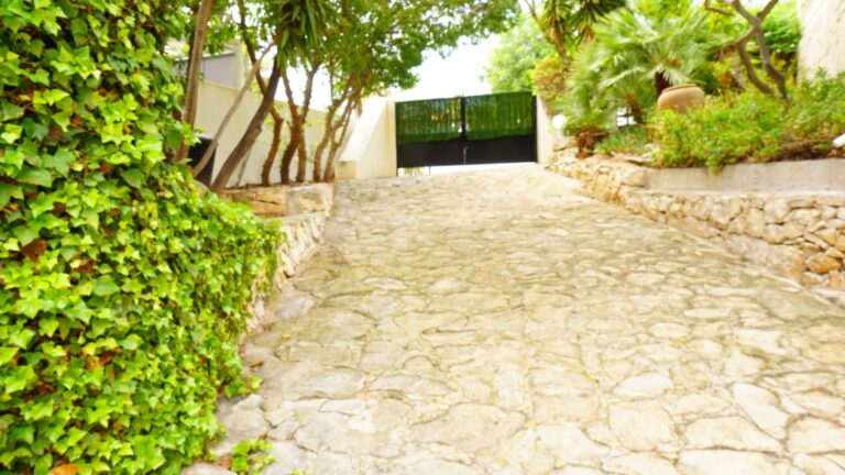 Private driveway with garden surroundings at a villa in La Fustera near the Mediterranean coast.
