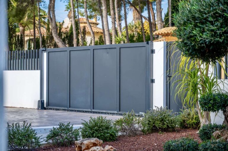 Private entrance gate at a single-level modern villa in Santa Clara, Altea with landscaped planting, secure access and Mediterranean garden setting