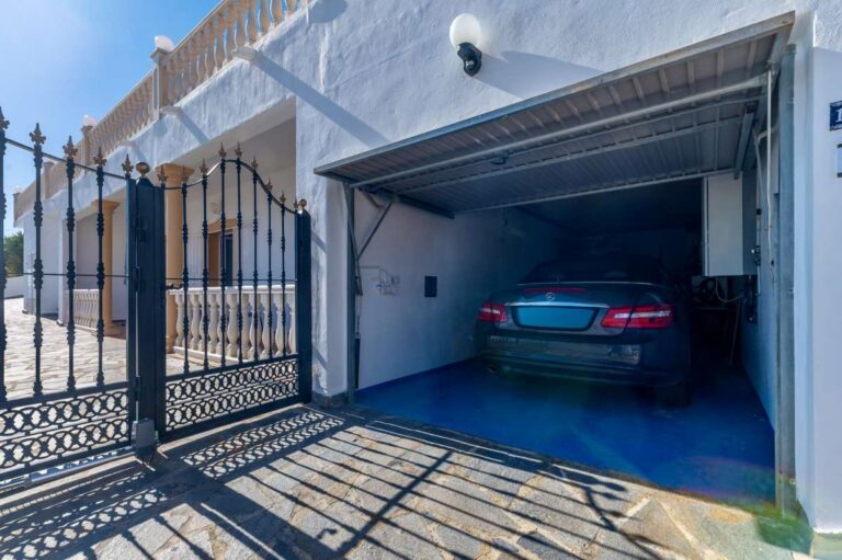 Private garage entrance with driveway and covered parking at a villa in Calpe.