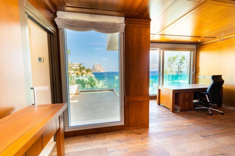 Private office inside a luxury villa in Calpe with wood panelling, desk area, terrace access and panoramic sea views