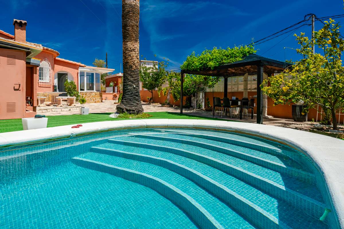 Private pool area with pergola and outdoor seating at a renovated Mediterranean villa in La Cometa, Calpe.