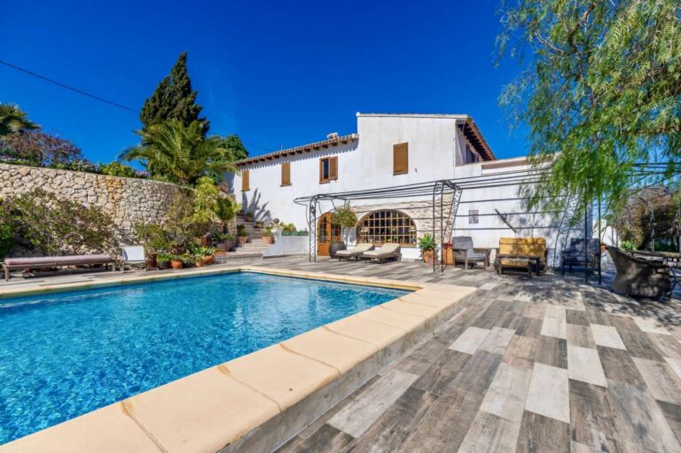 Private pool at a traditional Spanish finca near Moraira with tiled terrace, white façade, outdoor seating and rustic Mediterranean surroundings