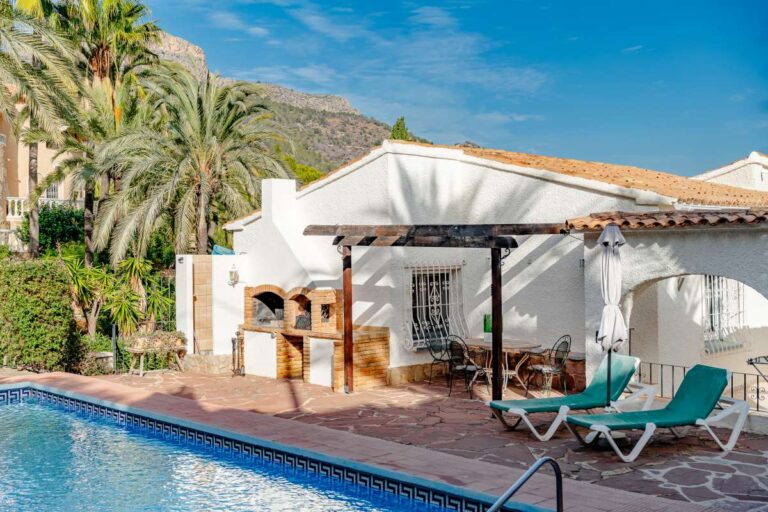 Private pool terrace with BBQ area, sun loungers and mountain surroundings at a Mediterranean villa in Maryvilla, Calpe.