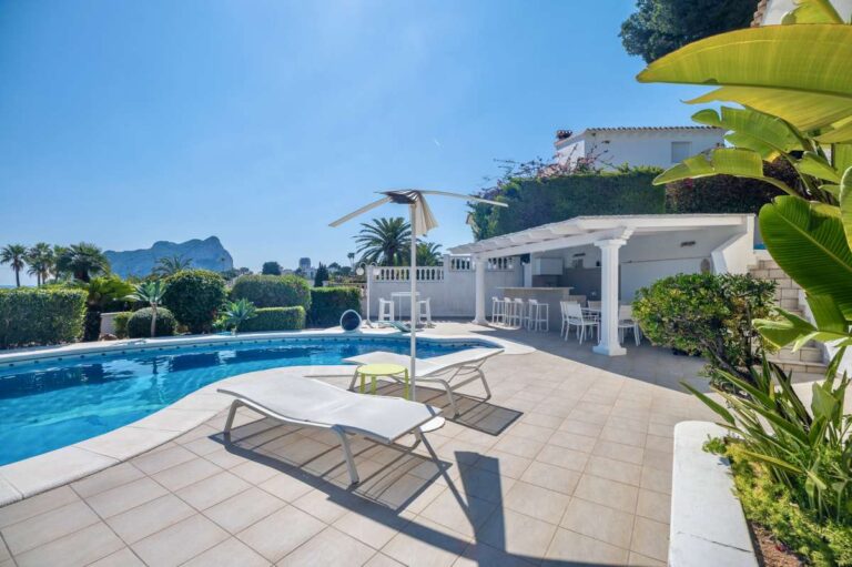 Private pool terrace with sun lounger, covered seating area, sea views, and Peñón de Ifach views at a villa in Calpe.
