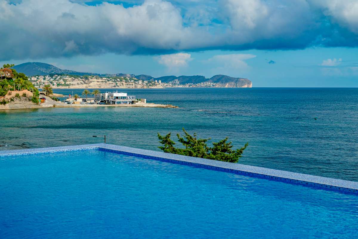 Private pool with panoramic sea views across the bay at a frontline villa in Les Bassetes, Benissa Coast.