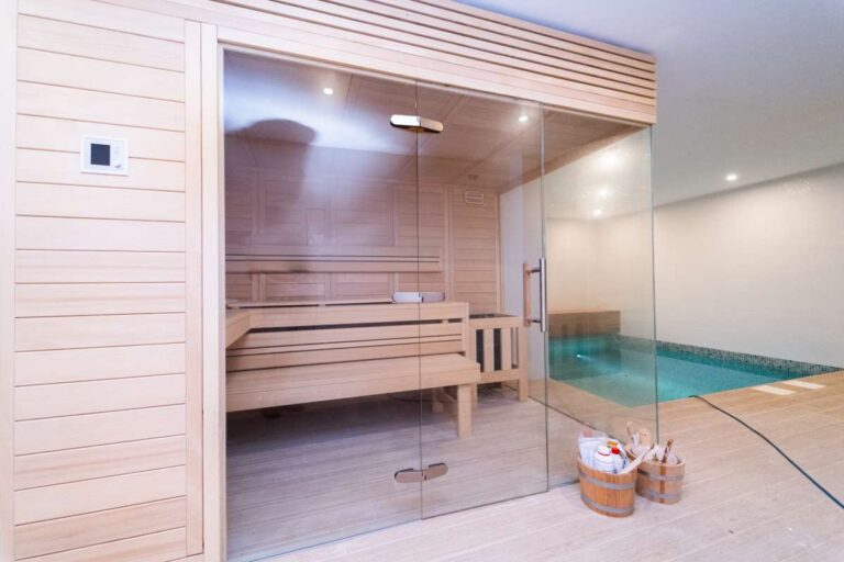 Private sauna inside a luxury villa in Calpe with glass front, wood finish and adjoining indoor plunge pool area