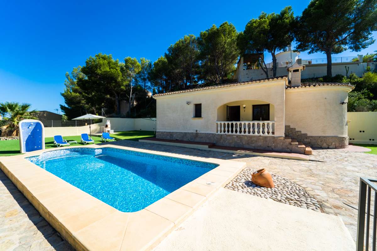 Private swimming pool and sun terrace beside a Mediterranean villa with mountain surroundings in Calpe.