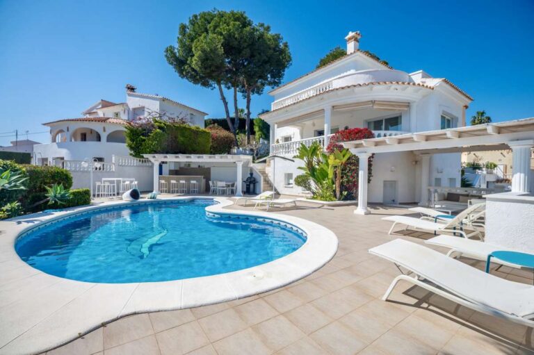 Private swimming pool and terrace area at a villa in Calpe with sea views.