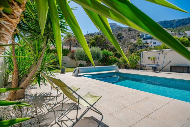 Private swimming pool and terrace at a modern villa in Calpe with Mediterranean planting and mountain views