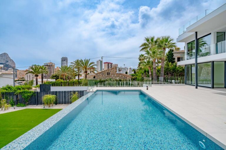 Private swimming pool at a modern second-line sea villa in La Calalga, Calpe with contemporary exterior, garden area and coastal surroundings