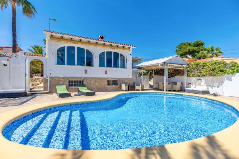 Private swimming pool at a renovated single-level villa in Moraira with arched windows, sun terrace and Mediterranean exterior