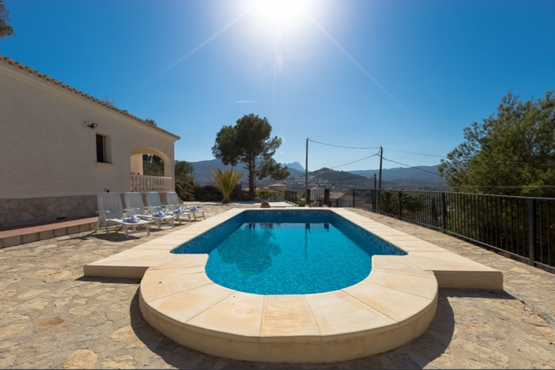 Private swimming pool with mountain views and sunny terrace at a Mediterranean villa in Calpe.