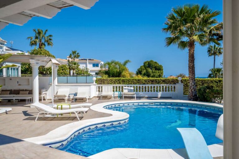 Private swimming pool with terrace space and sea views at a villa in Calpe.
