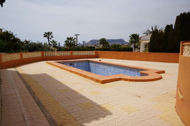 Private swimming pool with tiled terrace at a Mediterranean villa in Calpe within a 10-minute walk of La Calalga Beach.