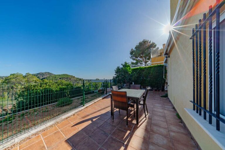 Private terrace at a semi-detached house in Calpe with outdoor dining area, mountain views and sea views in the distance