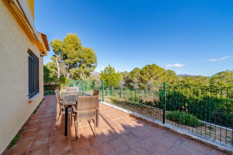 Private terrace at a semi-detached house in Calpe with outdoor dining space, mountain views and natural surroundings