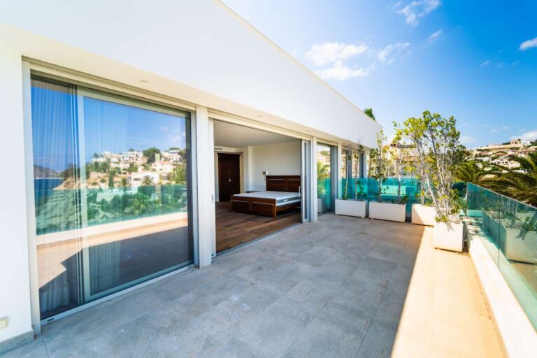 Private terrace outside the principal suite of a luxury villa in Calpe with glass balustrades, sea views and coastal surroundings
