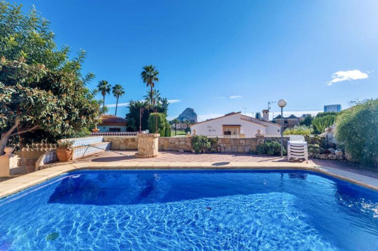 Rectangular swimming pool with Roman steps and terrace area at a spacious villa in Calpe.
