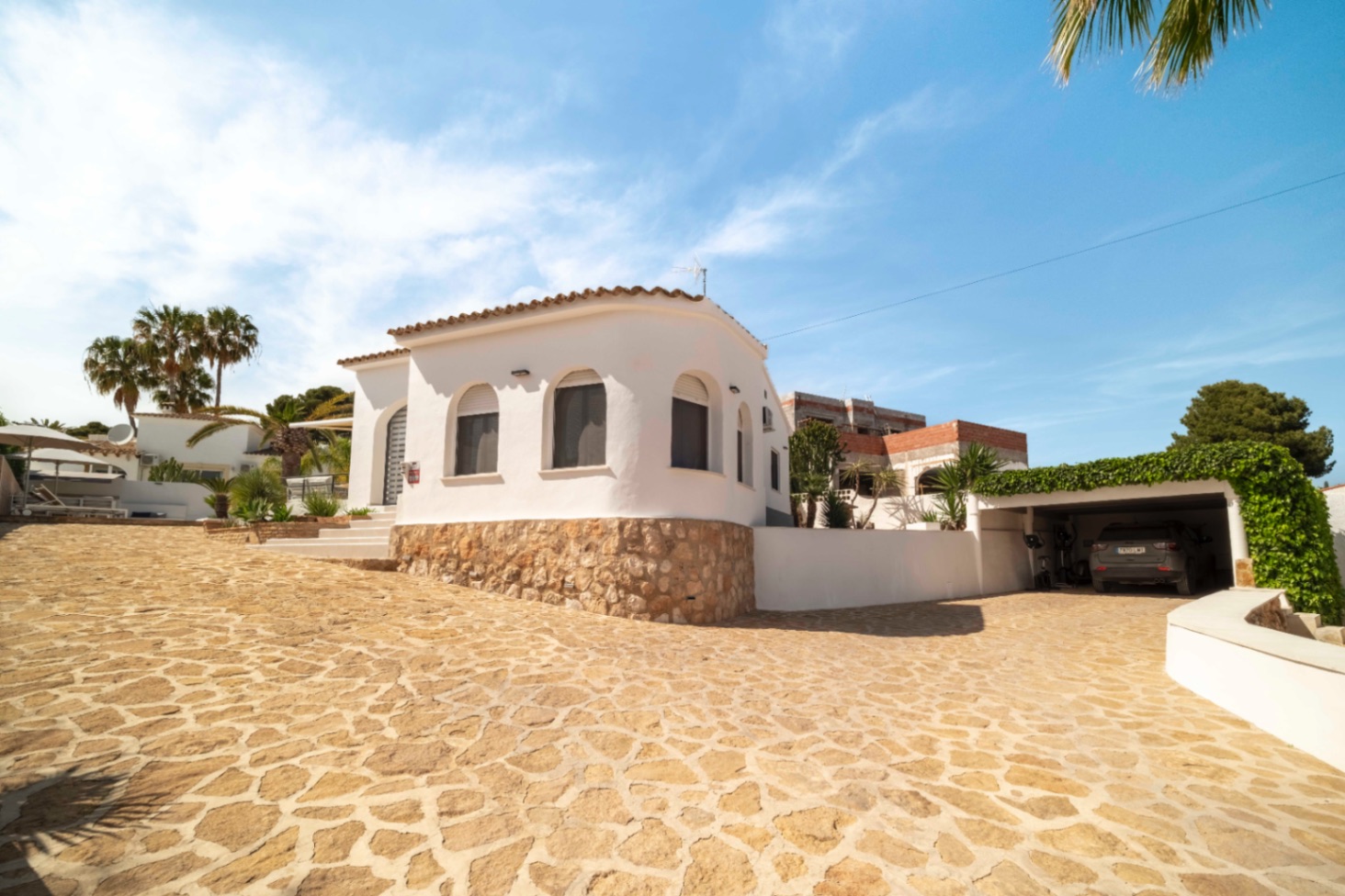 Renovated Ibiza-style villa exterior with stone terrace in Calpe