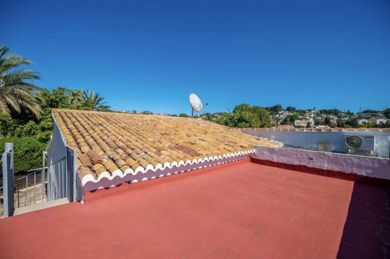 Rooftop solarium at a Mediterranean villa in Benissa Costa with tiled roof detail, open sky and views across the surrounding area