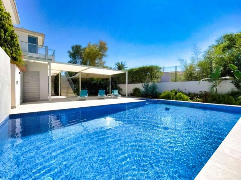 Saltwater swimming pool at a modern luxury villa in La Calalga, Calpe with terrace area, outdoor seating and landscaped surroundings