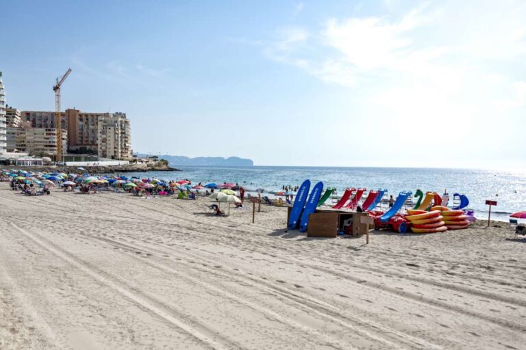 Sandy La Fossa Beach in Calpe with sunbeds, beach activities and Mediterranean sea views from a beachfront apartment