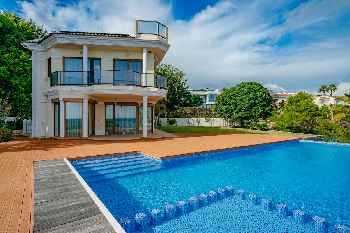 Sea-facing pool terrace with private swimming pool at a frontline villa in Les Bassetes.